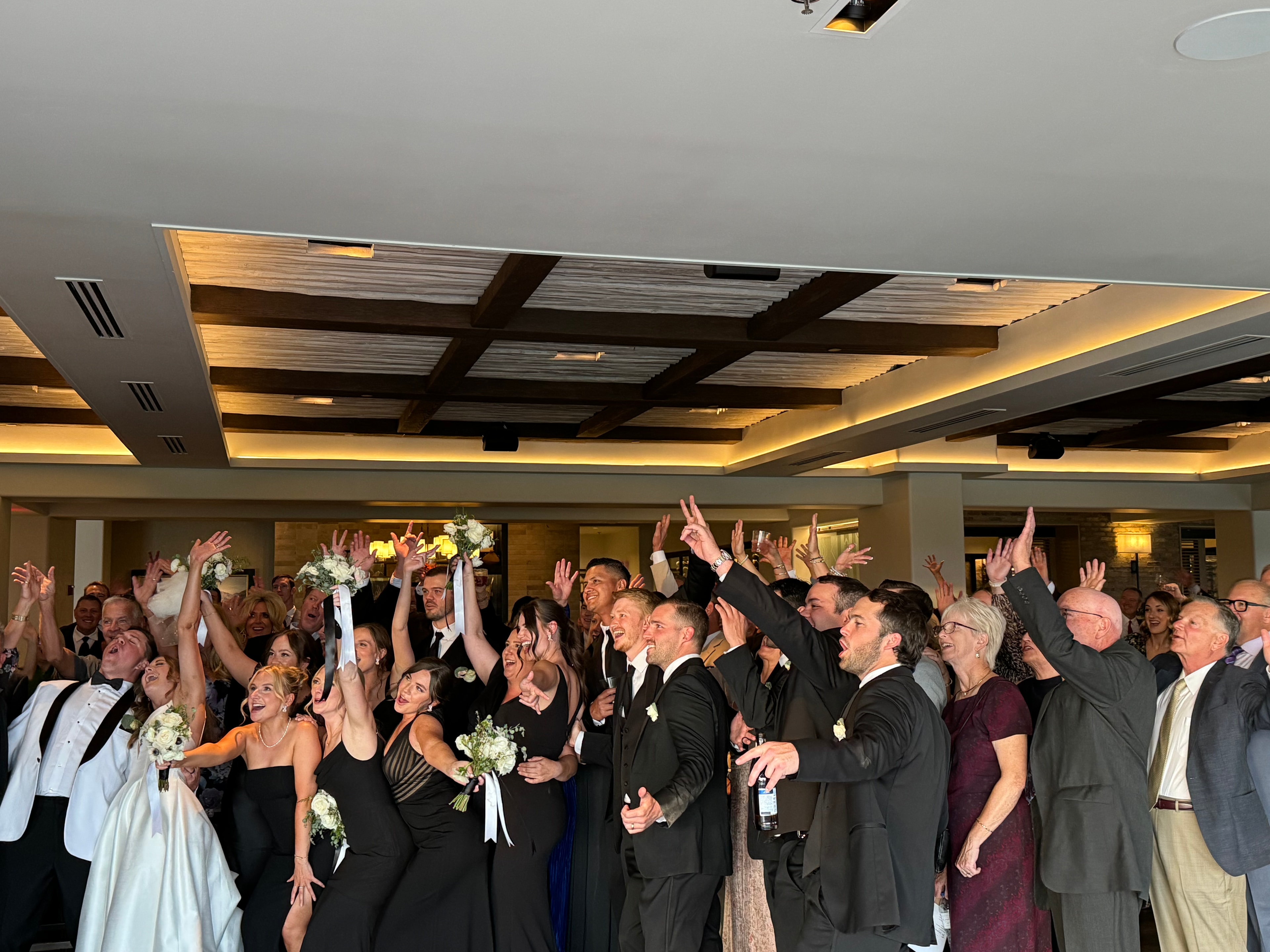 Wedding guests celebrating with hands raised